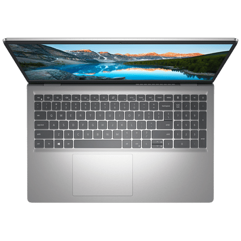 Top view of open Dell Inspiron 15 laptop showing full keyboard and high-resolution screen with mountain lake wallpaper