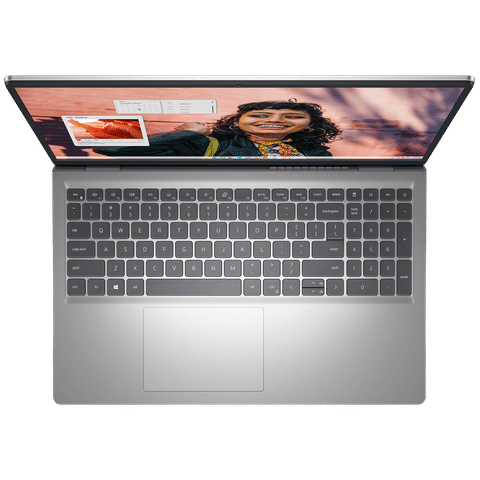 Top view of Dell Inspiron15 3530 laptop showing keyboard and display with a smiling woman on screen