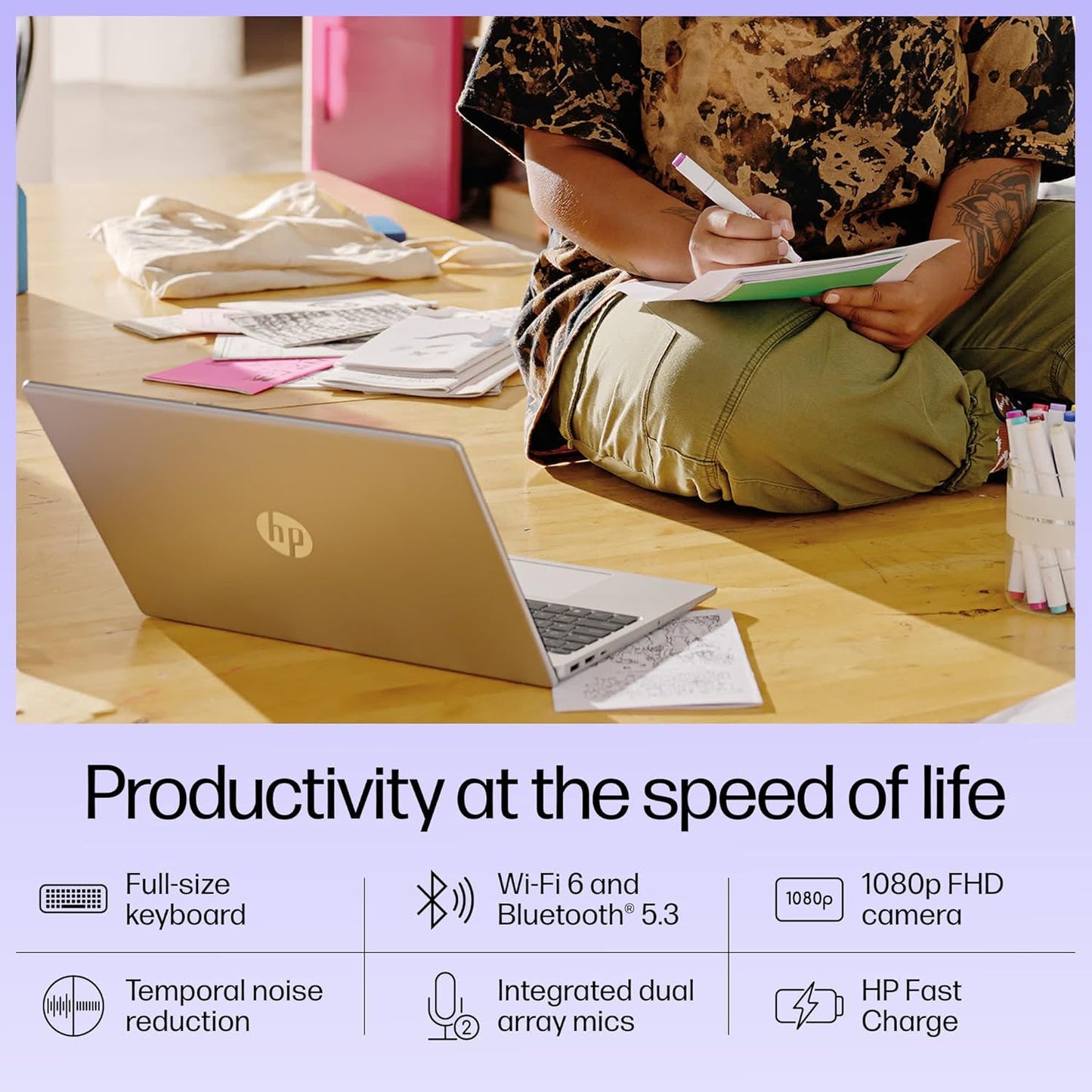 HP 15-fd0186TU laptop with full-size keyboard and 1080p FHD camera placed on floor near person writing in notebook