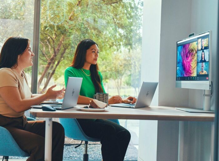 Two women using HP ZBook Firefly 16 G11 laptops during a video conference in a bright office