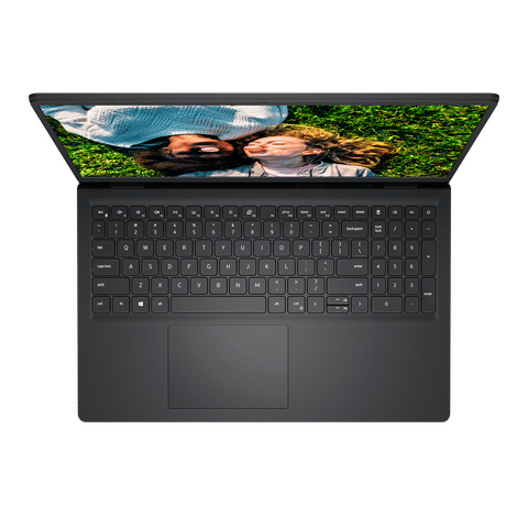 Top view of open Dell Inspiron 3520 laptop showing full keyboard and screen displaying couple lying on grass