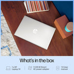 Closed silver HP 14-gr1022TU laptop on wooden desk surrounded by books and decor items