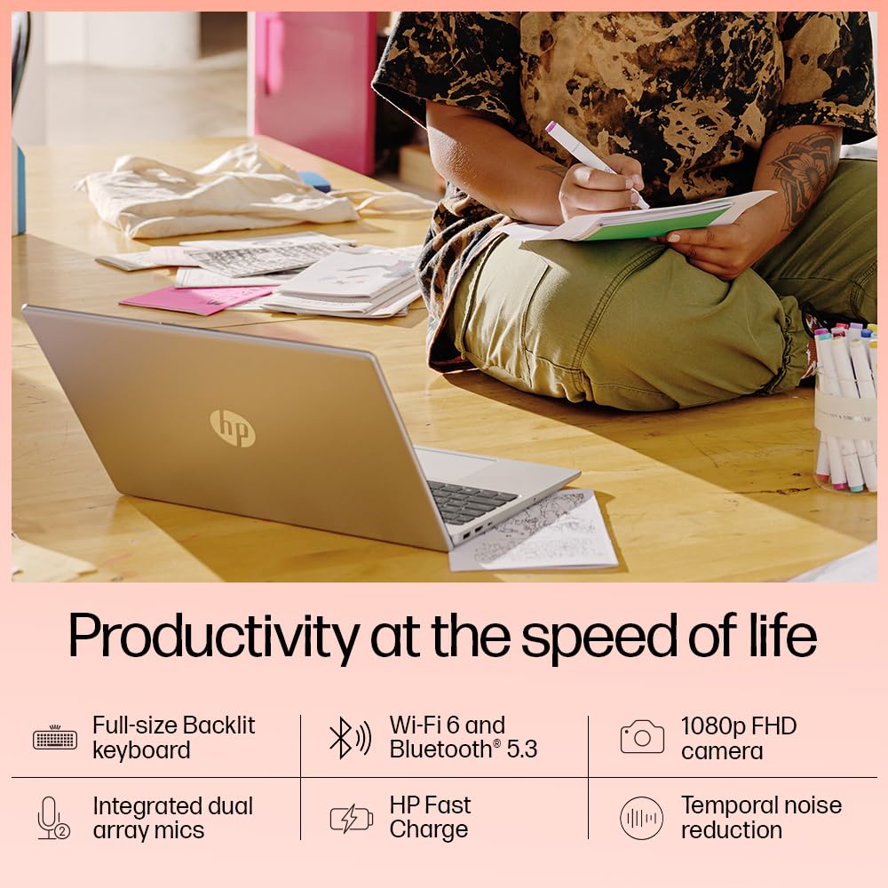 HP 15-fd0112TU natural silver laptop placed on wooden floor with person writing in notebook nearby