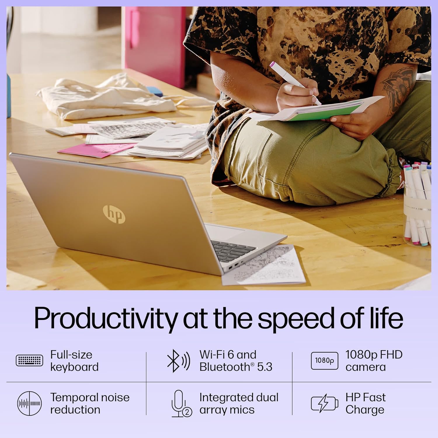 HP 15-fd0186TU laptop with full-size keyboard and 1080p FHD camera placed on floor near person writing in notebook