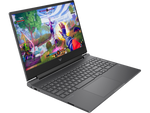 HP Gaming Victus 15 laptop open with colorful action game displayed on screen and black keyboard