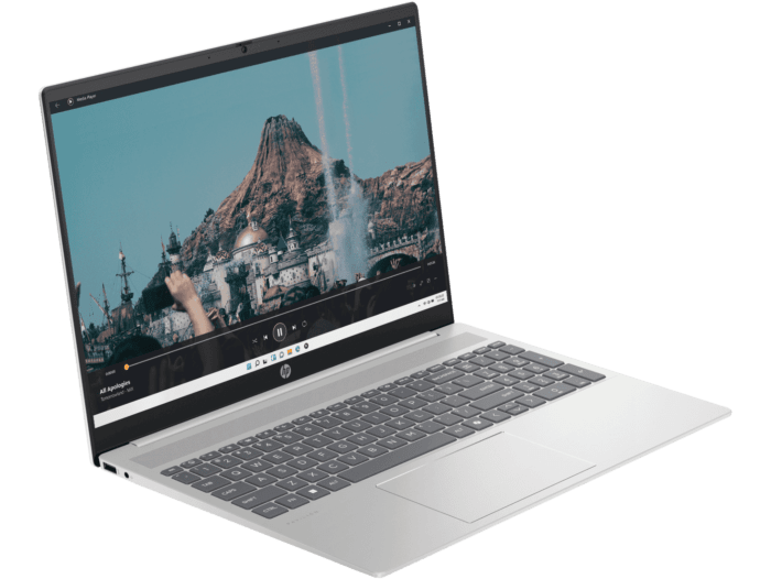 Silver HP Pavilion 16 laptop open showing a scenic mountain video on screen with full keyboard