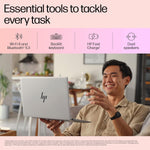 Smiling man holding and using HP Pavilion Aero Ryzen 5 laptop with backlit keyboard and dual speakers at home