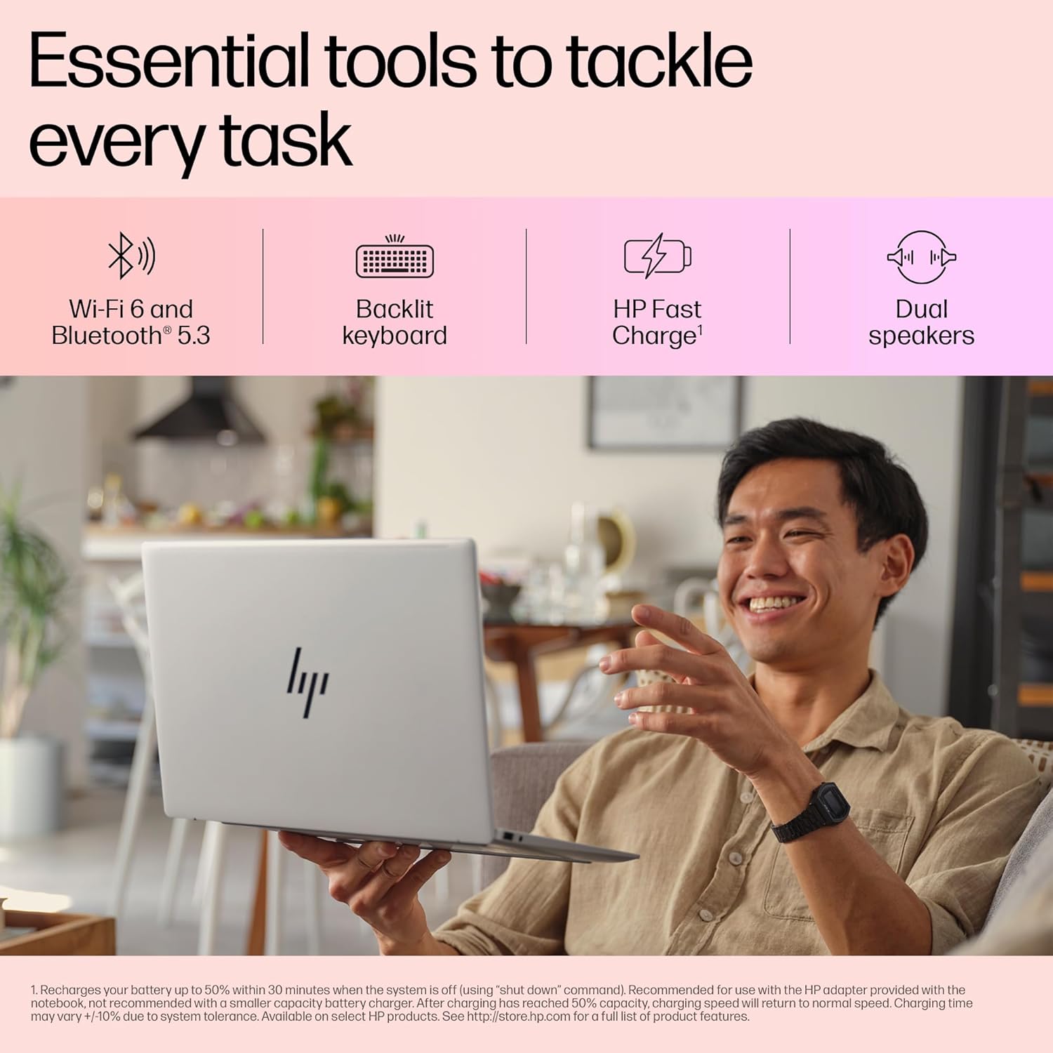Smiling man holding and using HP Pavilion Aero Ryzen 5 laptop with backlit keyboard and dual speakers at home