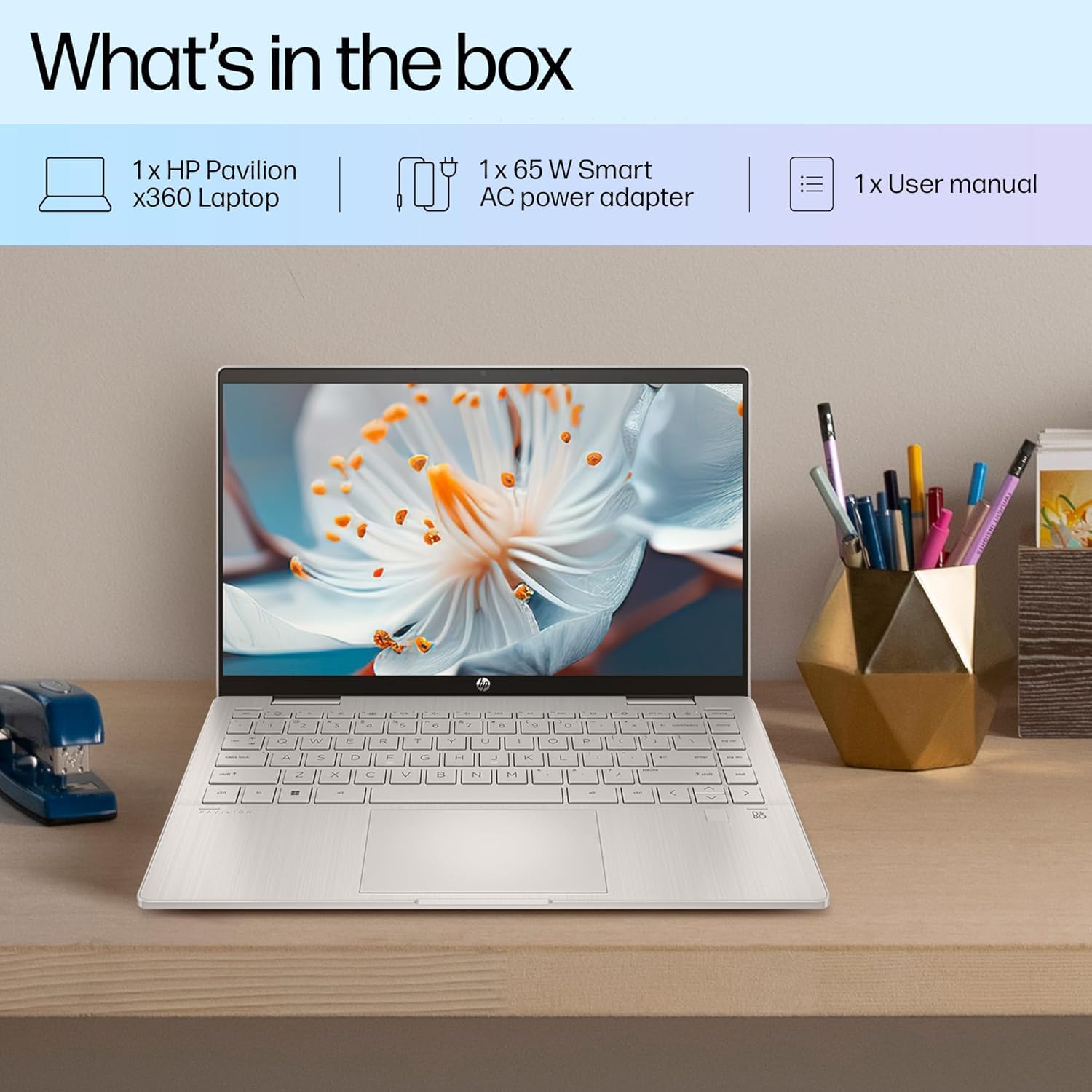 HP Pavilion x360 14 i5 13th Gen laptop open on desk with flower on screen and office supplies nearby