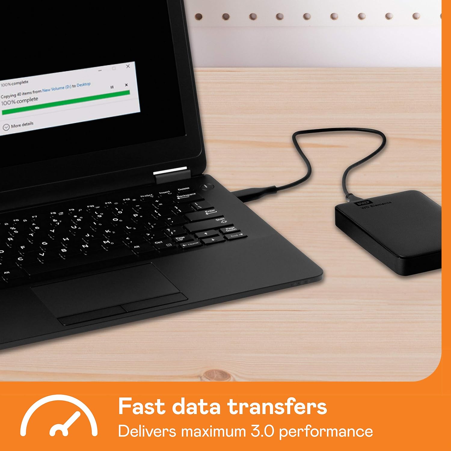 Western Digital Elements 2TB portable hard drive connected to a black laptop for fast data transfers