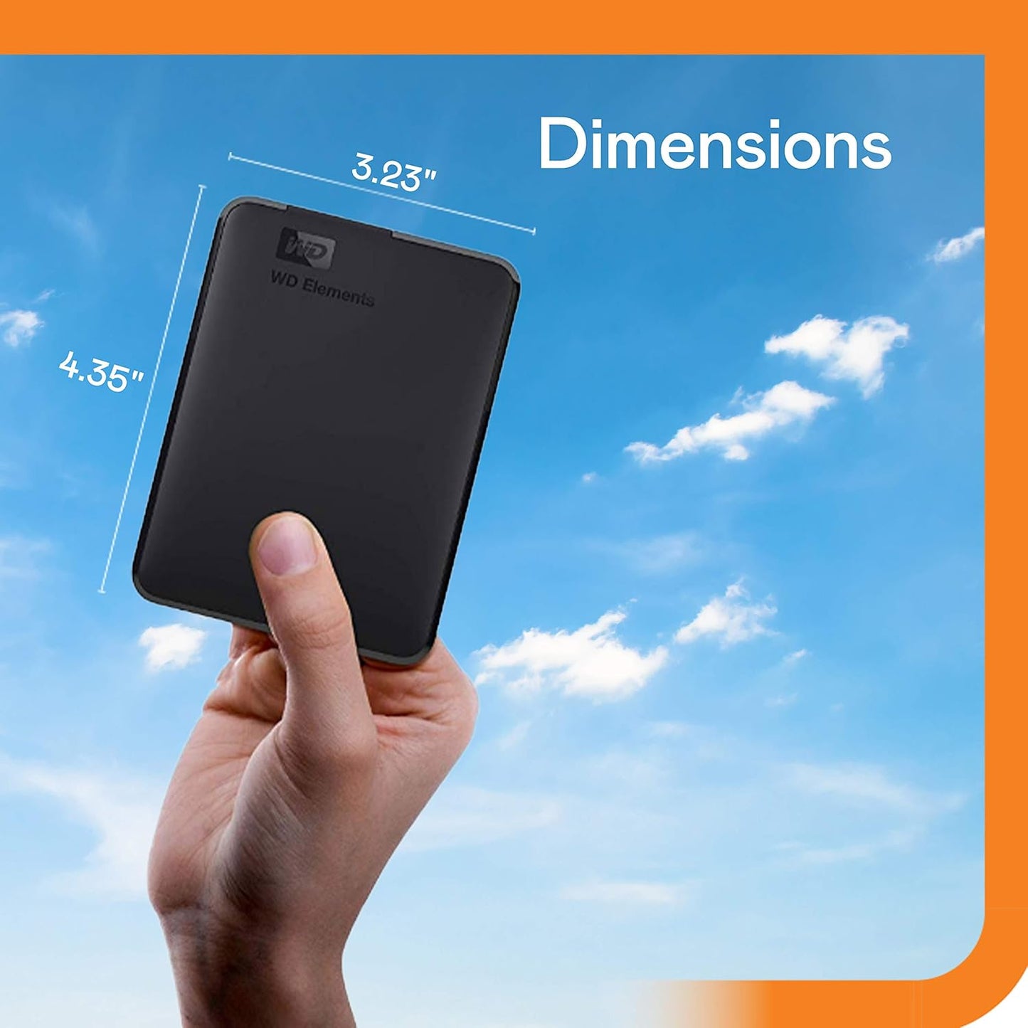 Hand holding Western Digital Elements 2TB portable hard drive showing compact dimensions against blue sky